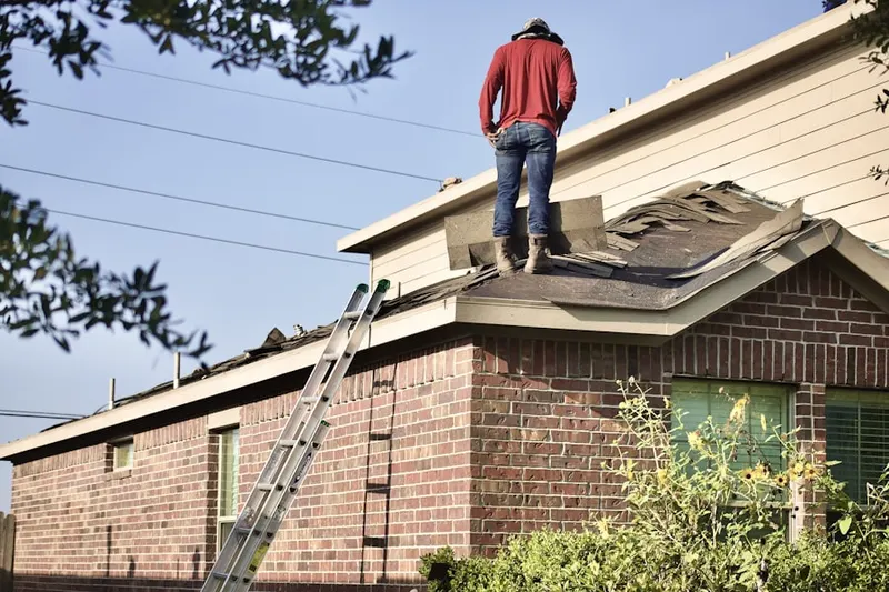 Professional roofer working on a residential roof in Pennbrooke